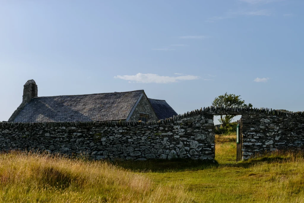 The entrance to Llangelynnin churchyard through the stone enclosure wall.