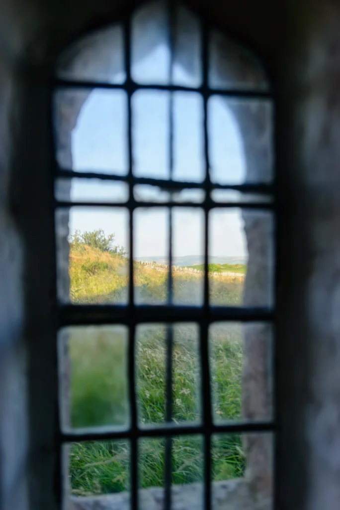A small stone-framed window in the men's chapel, looking east over the Conwy valley.