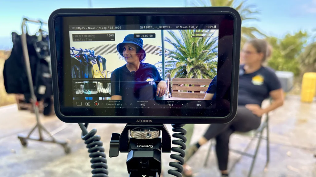 A view of a woman on a camera monitor in an interview situation.